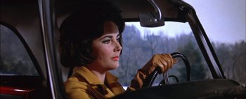 Movie still from “BUtterfield 8” (1960), directed by Daniel Mann – A woman sitting in the drivers seat of a car; Close Up shot, Low angle