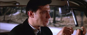 Movie still from “BUtterfield 8” (1960), directed by Daniel Mann – A person wearing a suit driving a car; Close Up shot, Low angle