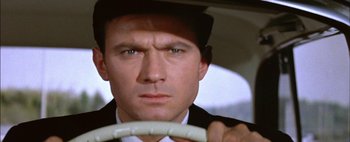 Movie still from “BUtterfield 8” (1960), directed by Daniel Mann – A person holding a steering wheel; Close Up shot, Over the shoulder angle