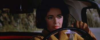Movie still from “BUtterfield 8” (1960), directed by Daniel Mann – A person sitting in a car; Close Up shot, Over the shoulder angle