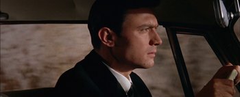 Movie still from “BUtterfield 8” (1960), directed by Daniel Mann – A person wearing a suit and tie; Close Up shot, Low angle