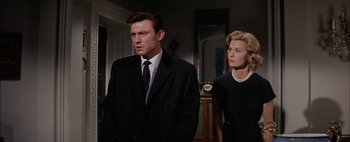 Movie still from “BUtterfield 8” (1960), directed by Daniel Mann – A man and a woman standing next to each other in a room; Medium shot, Low angle