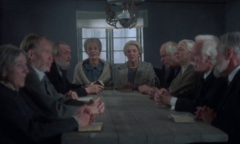 Movie still from “Babette's Feast” (1987), directed by Gabriel Axel – A group of people sitting around a table; Wide shot, High angle