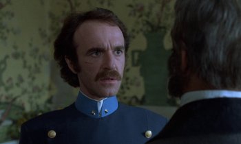 Movie still from “Babette's Feast” (1987), directed by Gabriel Axel – A man in a blue uniform looking at a man in a black suit; Close Up shot, Over the shoulder angle