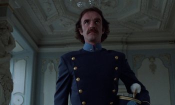 Movie still from “Babette's Feast” (1987), directed by Gabriel Axel – A man in a blue uniform standing next to a ceiling; Medium shot, Low angle