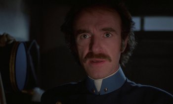 Movie still from “Babette's Feast” (1987), directed by Gabriel Axel – A person with a mustache wearing a uniform; Close Up shot, Low angle