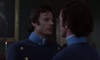 Movie still from “Babette's Feast” (1987), directed by Gabriel Axel – A man looking at his reflection in a mirror; Close Up shot, Over the shoulder angle