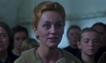 Movie still from “Babette's Feast” (1987), directed by Gabriel Axel – A person wearing a necklace; Close Up shot, Over the shoulder angle
