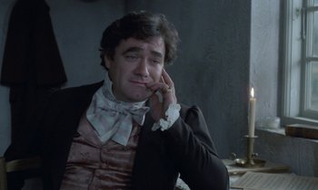 Movie still from “Babette's Feast” (1987), directed by Gabriel Axel – A man sitting in front of a lit candle; Close Up shot, High angle