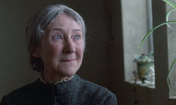 Movie still from “Babette's Feast” (1987), directed by Gabriel Axel – An older woman looking up at the sky; Close Up shot, Low angle