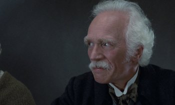 Movie still from “Babette's Feast” (1987), directed by Gabriel Axel – An older man with a mustache and a beard; Close Up shot, Low angle