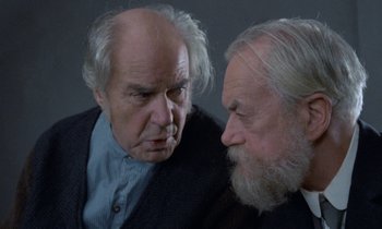 Movie still from “Babette's Feast” (1987), directed by Gabriel Axel – Two older men are looking at each other; Close Up shot, Over the shoulder angle