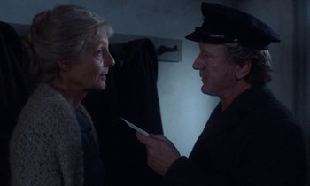 Movie still from “Babette's Feast” (1987), directed by Gabriel Axel – A man and a woman are looking at each other; Close Up shot, Over the shoulder angle