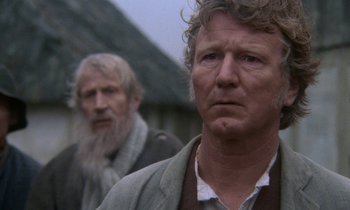 Movie still from “Babette's Feast” (1987), directed by Gabriel Axel – Two men standing next to each other in front of a building; Close Up shot, Over the shoulder angle