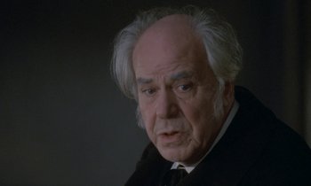 Movie still from “Babette's Feast” (1987), directed by Gabriel Axel – An old man with a white beard and white hair looking at the camera; Close Up shot, Low angle