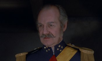 Movie still from “Babette's Feast” (1987), directed by Gabriel Axel – An older man in a military uniform with a mustache; Close Up shot, Low angle