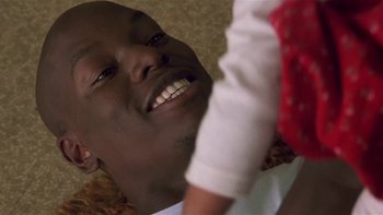 Movie still from “Baby Boy” (2001), directed by John Singleton – A person with a smile on their face; Close Up shot, Low angle