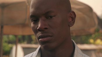 Movie still from “Baby Boy” (2001), directed by John Singleton – A man's face in a white shirt; Close Up shot, Low angle