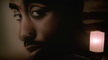 Movie still from “Baby Boy” (2001), directed by John Singleton – A woman's face with a piercing on it; Extreme Close Up shot, Overhead angle