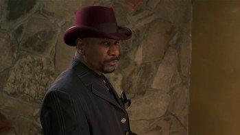 Movie still from “Baby Boy” (2001), directed by John Singleton – A man in a suit and a red hat; Close Up shot, Low angle