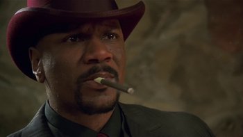 Movie still from “Baby Boy” (2001), directed by John Singleton – A person with a cigarette holder; Close Up shot, Low angle