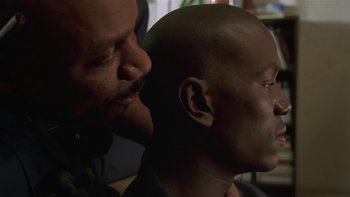 Movie still from “Baby Boy” (2001), directed by John Singleton – A man with a shaved head and a man with a shaved head; Close Up shot, Over the shoulder angle