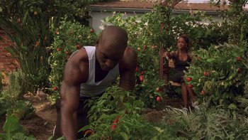 Movie still from “Baby Boy” (2001), directed by John Singleton – A man and a woman working in a vegetable garden; Medium shot, Low angle
