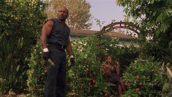 Movie still from “Baby Boy” (2001), directed by John Singleton – A man and a woman are in a garden; Medium shot, Low angle