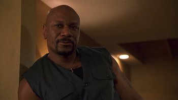 Movie still from “Baby Boy” (2001), directed by John Singleton – A man with a beard and a vest is posing for a picture; Close Up shot, Low angle