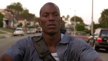 Movie still from “Baby Boy” (2001), directed by John Singleton – A person wearing a shirt; Close Up shot, Low angle