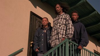 Movie still from “Baby Boy” (2001), directed by John Singleton – A group of men standing next to each other on steps; Medium shot, Low angle