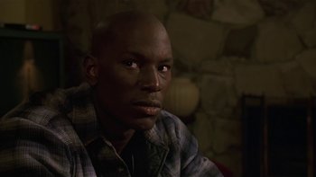 Movie still from “Baby Boy” (2001), directed by John Singleton – A person wearing a plaid shirt; Close Up shot, Low angle