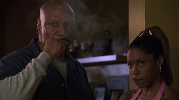 Movie still from “Baby Boy” (2001), directed by John Singleton – A man smoking a cigarette in front of a woman; Close Up shot, Low angle