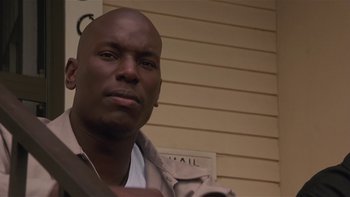 Movie still from “Baby Boy” (2001), directed by John Singleton – A man with a bald head is standing in front of a wall; Close Up shot, Low angle