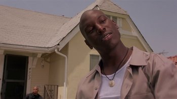 Movie still from “Baby Boy” (2001), directed by John Singleton – A man standing in front of a house with his eyes wide open; Close Up shot, Low angle
