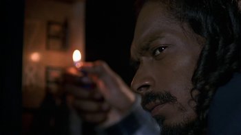 Movie still from “Baby Boy” (2001), directed by John Singleton – A person lighting a candle; Close Up shot, Low angle