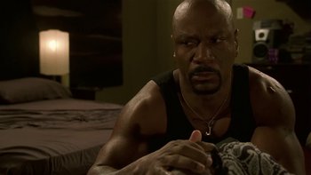 Movie still from “Baby Boy” (2001), directed by John Singleton – A man sitting on a bed with his hand on his chin; Close Up shot, Low angle