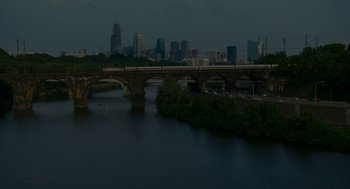Movie still from “Baby Mama” (2008), directed by Michael McCullers – A view of a city skyline at night with a bridge over a river in the foreground; Extreme Wide shot, High angle