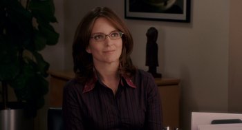 Movie still from “Baby Mama” (2008), directed by Michael McCullers – A woman wearing glasses sitting in front of a table; Close Up shot, Over the shoulder angle