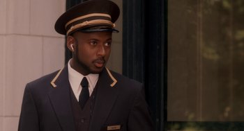 Movie still from “Baby Mama” (2008), directed by Michael McCullers – A man in a suit and tie wearing a hat; Close Up shot, Over the shoulder angle