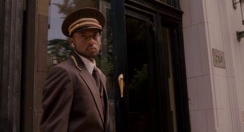 Movie still from “Baby Mama” (2008), directed by Michael McCullers – A man in a uniform standing in front of a door; Close Up shot, Over the shoulder angle