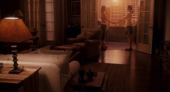 Movie still from “Baby Mama” (2008), directed by Michael McCullers – Two women are holding hands in a living room; Wide shot, High angle