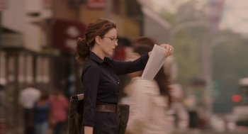 Movie still from “Baby Mama” (2008), directed by Michael McCullers – A woman in black shirt holding a piece of paper; Medium shot, Over the shoulder angle