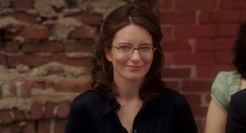 Movie still from “Baby Mama” (2008), directed by Michael McCullers – A person wearing glasses and smiling; Close Up shot, Over the shoulder angle