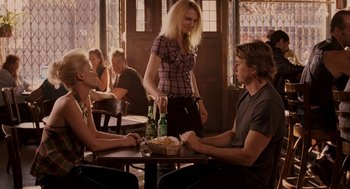 Movie still from “Baby Mama” (2008), directed by Michael McCullers – A man and a woman sitting at a table with a basket; Medium shot, Over the shoulder angle