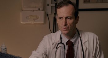 Movie still from “Baby Mama” (2008), directed by Michael McCullers – A man in a white lab coat with a stethoscope around his neck; Close Up shot, Low angle