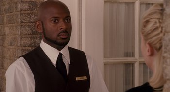 Movie still from “Baby Mama” (2008), directed by Michael McCullers – A man in a vest and tie standing next to a window; Close Up shot, Over the shoulder angle