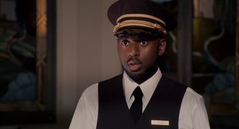 Movie still from “Baby Mama” (2008), directed by Michael McCullers – A man wearing a hat and a vest and tie; Close Up shot, Over the shoulder angle