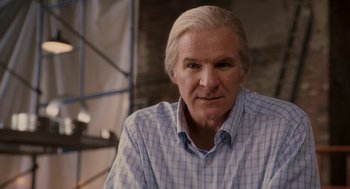 Movie still from “Baby Mama” (2008), directed by Michael McCullers – An older man in a blue and white checkered shirt; Close Up shot, Over the shoulder angle