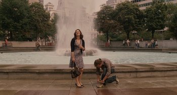 Movie still from “Baby Mama” (2008), directed by Michael McCullers – A man kneeling down next to a woman in front of a fountain; Wide shot, High angle
